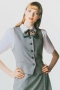 These slim cut gray vests are trendy office wears sporting a curved U neck. With five contrast front buttons in black, these vests put to view neatly piped lower and ticket pockets, overlapping each other. They have an angled V style front cut, 1 inch deep, with two stylish side vents. You can donn these handmade ravishing vests with squared front bottoms and low armholes over short sleeves custom shirts for a classy formal look.