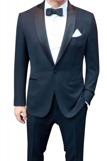 This mens custom made 120s wool black tuxedo - featuring a bespoke slim fit tuxedo jacket and handmade dress pants - is ideal for weddings and formal events. The mens custom made jacket has a shawl collar with 3-inch-wide satin-facing lapels, 1 angled upper welt pocket, 2 double piped lower pockets, hand moulded shoulders, and 1 front close button. The mens bespoke slim fit tuxedo pants have hand sewn cuff hems at the bottom, satin piping on the side seam, 2 front slash pockets, a 2 point button and hook closure, and a zip fly.