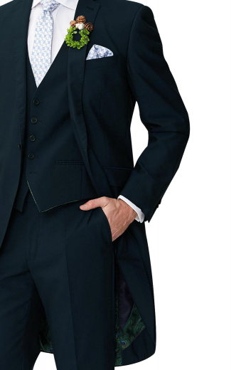 Style no.16085 - Mens must buy tailor made dark navy blue cashmere tailed tuxedo. Features a bespoke slim fit jacket, a custom made vest, and dress pants. The mens handmade tailed jacket features 2 notch lapels, 1 boutonniere on the left lapel, 1 upper welt pocket, 2 lower flapped pockets, and a flapped ticket pocket on the left. The mens custom made vest has 5 front buttons, 2 piped lower pockets, and an adjustable cloth back with a buckle. The mens bespoke tux pants have a 2 point button and hook closure, a zip fly, and 2 front slash pockets. 