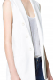 Classy womens handmade cotton vest in ivory. A perfect formal that you can wear to interviews and meetings. This tailor made cotton vest for women has a slim cut fitting further boosted with the inclusion of a cloth back with an adjustable buckle so that you can drape this womens slim fit vest around your waist as tightly as you want. This womens bespoke vest with a hand sewn peak lapel collar also features 6 front buttons. Take a bite at luxury with the inclusion of this stunner in your summer wardrobe of corporate wear.