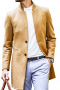 This men's bright, tan colored coat is tailor made in a fine wool and tweed and cut to a slim fit, featuring a single breasted button closure and welt pockets. 