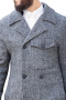 This men's custom made grey colored coat is tailor made in a fine wool and tweed and cut to a slim fit, featuring a double breasted button closure, slanted pockets, and edge stitched lapels. It is a classic winter coat, sure to become a staple in your everyday wardrobe!