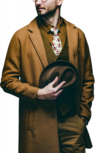 This men's custom made caramel colored coat is tailor made in a fine wool and tweed and cut to a slim fit, featuring a single breasted button closure, slanted welt pockets, and edge stitched pockets and lapels. It is a classic winter coat, sure to become a staple in your everyday wardrobe!