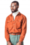 A custom loose tailored cut shirt made just for you in a great brick orange. This men's tailored shirt features an Ainsley collar, rounded barrel cuffs, and two flapped, buttoned pockets and a classic placket front, a plain back, and a standard yoke.