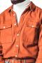 A custom loose tailored cut shirt made just for you in a great brick orange. This men's tailored shirt features an Ainsley collar, rounded barrel cuffs, and two flapped, buttoned pockets and a classic placket front, a plain back, and a standard yoke.