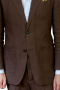 This brown men's suit is tailor made in a fine wool blend and cut to a slim fit, featuring a single breasted button closure, notch lapels, and slash pockets. 