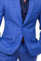 This blue textured pant suit is a bold option for any formal occasion. It features a single breasted button closure and notch lapels, and is custom made in a wool blend.