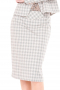 A sophisticated plaid and stylish women's made to measure modern skirt suit, expertly tailored to fit and flatter and body type. This elegant knee length skirt suit features a center back slit and a sleek single breasted closure. 