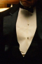 In a sleek and stylish classic black is this men's single breasted wedding tuxedo with wide notch lapels that flatter the figure. This vintage classic tuxedo can be custom tailored to fit you right for the special occasion. 