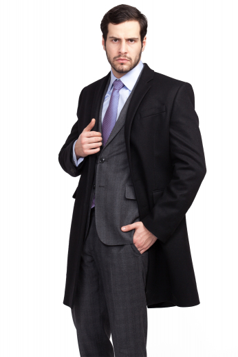 This men's sleek black winter coat is tailor made in a fine wool blend and cut to a slim fit, featuring a single breasted button closure, edge stitched lapels, and flap pockets. 